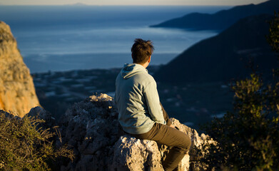 An attractive man is hiking, trekking in the mountains.