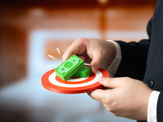 A businessman sets a goal to make money. Financial ambition, profit driven mindset. Entrepreneurial motivation, strategic planning. Personal success goals and wealth creation.