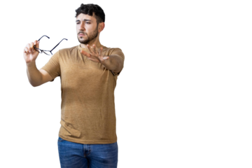 Young man holding eyeglasses and making stop gesture with hand. PNG