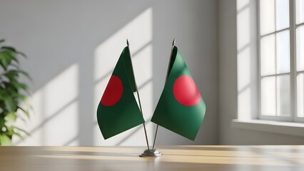 Two bangladeshi flags on a table in a bright room