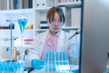 A chemistry researcher in a laboratory surrounded by scientific equipment and test tubes, representing innovation, scientific development, and modern medical research environment.
