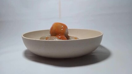 Cilok, a snack made from tapioca flour or aci dough and shaped into balls like meatballs, served with sweet and spicy peanut sauce or chili sauce.