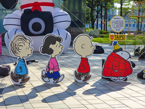 Taipei, Taiwan, Xinyi District, December 15, 2025 &ndash; Snoopy Family Cartoon Character Standees at Christmas with Taipei City Landmarks