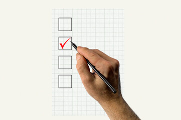 Hand with pencil voting. Hand marking vote box with checkmark.