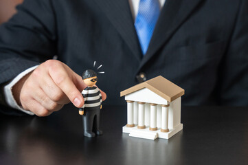 The bank and the bank robber. Keep your savings safe. Prevent money laundering. Financial crime prevention concept, banking security systems. Protection of deposits, compliance measures.