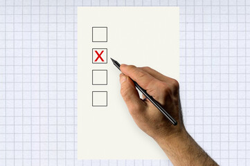Hand with pencil voting. Hand marking vote box with cross.