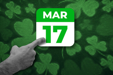 St. Patrick Day calendar, March 17. Halftone collage: a hand pointing to a calendar with the date March 17.