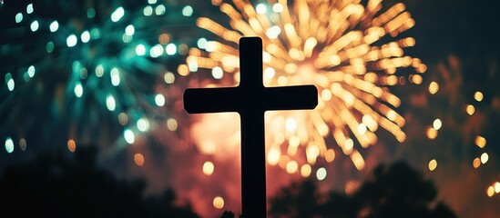 Christian Cross Silhouette Against Vibrant Blurred Fireworks Bokeh Lights at Night