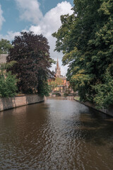 Fototapeta premium Historic medieval city of Bruges, Belgium. Beautiful scenic view of canals, ancient architecture and landmarks in the Venice of the North.