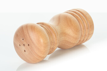 Wooden salt shaker, isolated on transparent background, with reflection and shadows. Natural rustic kitchen accessory, eco utensil for cooking, dining, and seasoning