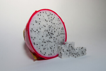 Fresh Dragon Fruit (Pitaya) on White Background, Exotic Tropical Fruit with Vibrant Pink Skin and Juicy Pulp, Healthy Food Concept