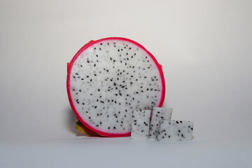 Fresh Dragon Fruit (Pitaya) on White Background, Exotic Tropical Fruit with Vibrant Pink Skin and Juicy Pulp, Healthy Food Concept