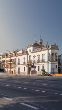 Plaza de Toros de la Real Maestranza de Caballeria de Sevilla timelapse hyperlapse. Traffic passing in front of its facade. Historic bullring in Seville, Spain, known for its bullfighting festivals.