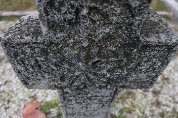 Shallow depth of field (selective focus) details with inscriptions and texture of an old orthodox christian stone cross