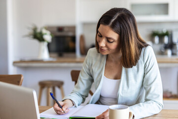 Remote work, window and writing with woman in home office for agenda, planning or research. Desk, notebook and view with freelance employee in apartment for schedule of small business startup.