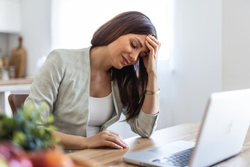 Laptop, remote work and stress with woman at window in home for burnout, pressure or tension. Computer, headache and overworked with freelance employee in apartment for planning or research fatigue.