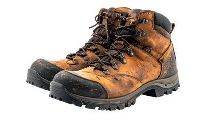 Weathered, sturdy hiking boots, brown leather, laced, black accents, isolated on black