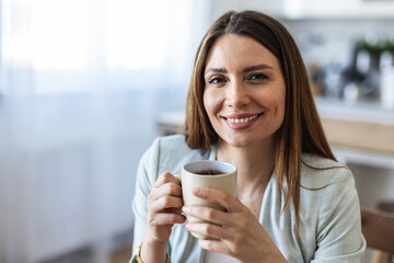 Thinking, planning and working from home on laptop while entrepreneur drinks coffee, tea or hot drink to help concentrate. Freelance blogger or writer with vision ideas, strategy and blog innovation.