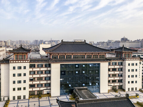 Aerial view of a building with traditional Chinese architecture set against a hazy urban backdrop, Xi'An, Shaanxi, China.