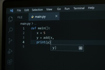 A screen shows Python code where a main function is created, a variable is assigned, and a print statement is prepared to display the result.
