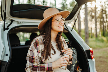 Woman enjoying road trip and nature camping adventure