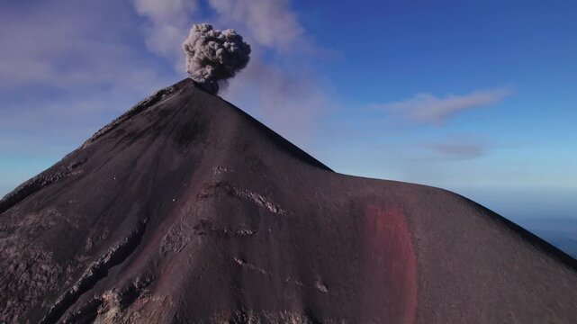 Acatenango, Guatemala - A Dark Volcanic Cone Rises Sharply as a Thick Plume of Ash Billows from its Summit - Tilt Reveal Drone Shot