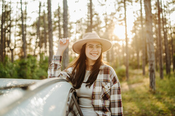 Woman enjoying golden hour in a pine forest
