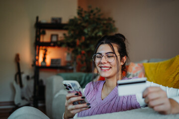 Woman buying online with smartphone and credit card