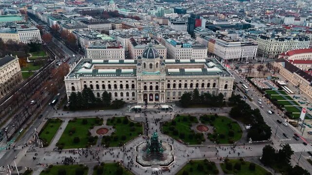 Aerial drone shot panning right over the Austrian National History Museum in Vienna, showing its grand fa&ccedil;ade and surrounding streets, with the Vienna cityscape visible under bright winter sunlight.