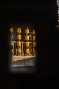 View of warm yellow lanterns casting a soft glow on a wooden structure evoking a sense of history and tranquility, Chongqing, Chongqing, China.