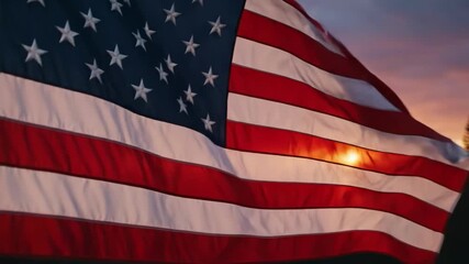 Waving american flag against a dramatic sunset sky over mountains