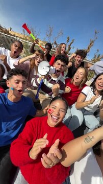 Group of excited fans celebrating and cheering for their favorite team at a stadium