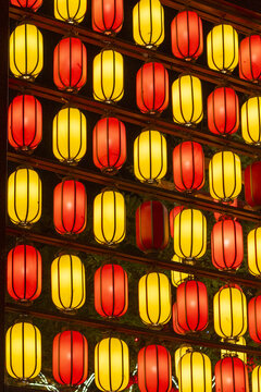 View of rows of vibrant, glowing red and yellow lanterns illuminate the dark night with a warm, festive glow, Xi'An, Shaanxi, China.