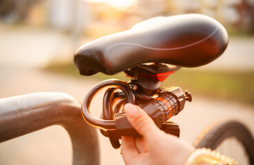 Girl Sets The Code On A Bike Lock And Secures The Bicycle At The Bike Parking