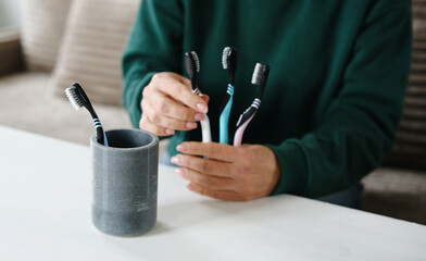 Girl Placing Toothbrushes In Holder For Brushes For Whole Family