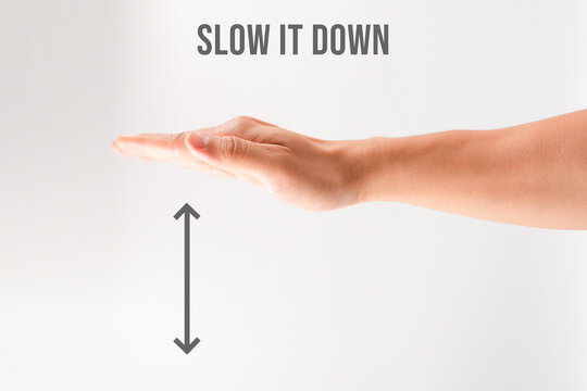Hands flat (palms down) or Slow Down hand sign isolated on white
