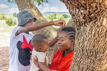 village african family mother with braids holding the child teenager playing with her hair