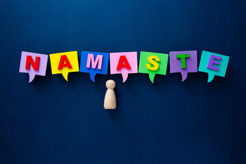 Person standing below colorful namaste word bubbles