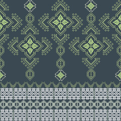 Yellow and white cross-stitch ethnic boho seamless pattern on a dark green background. Tribal pattern. Folk motif. Textile rapport. Pixel vintage pattern. Design for fabric edge and wallpaper.