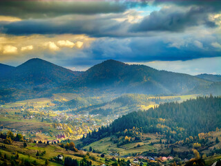 Sunny Autumn Carpathians with Puffy White During The Sunset