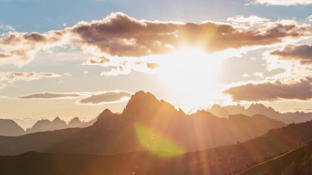 Timelapse of sunset over mountain peak, Dolomites, Italy 
