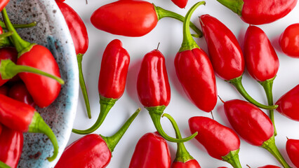 Vibrant red jalapeno pepper on a white background with space for text, ideal for food and culinary concepts.Group of ripe red jalapeno peppers .