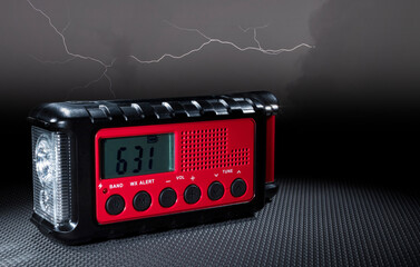 Emergency weather radio and storm behind