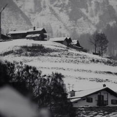 village huts in winter in snowfall