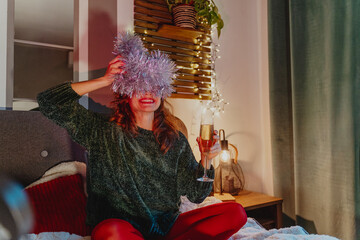 Young pretty woman drinking champagn during Christmas Holidays retro style photo