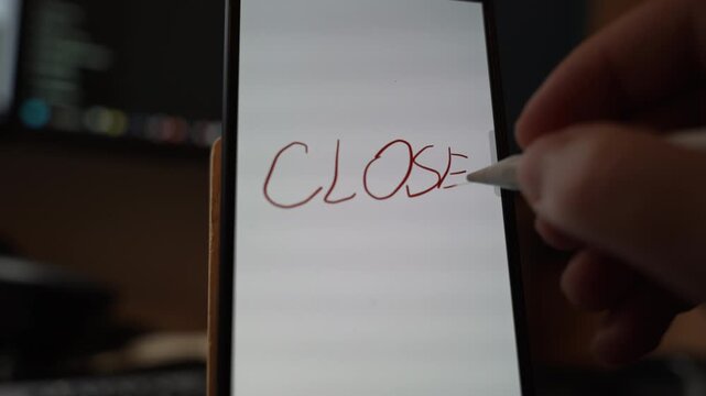 Close view of the word CLOSE handwritten with a stylus on a smartphone screen indicating decision completion shutdown or ending state through digital note taking and modern mobile interaction indoors