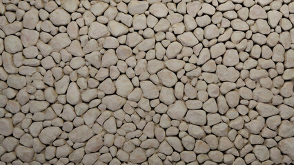 A natural, irregular pattern of small, light-colored pebbles creating a textured surface with subtle shadows and highlights