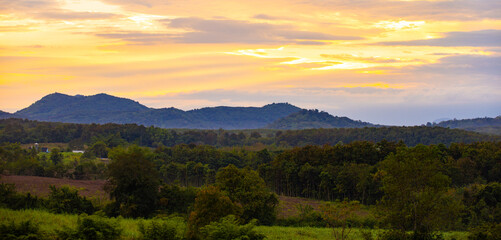 A photograph of the morning sky. Sunrise. Mountain landscape with mist surrounding the mountains.