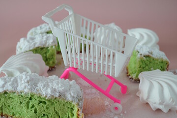 Confectionery cupcake and marshmallows and a basket.