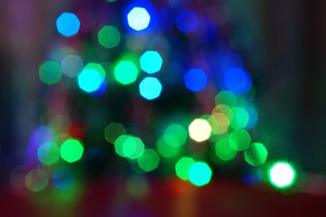 Blurred abstract Christmas background. Bokeh. Toys and glowing illumination. Blue-green shade.